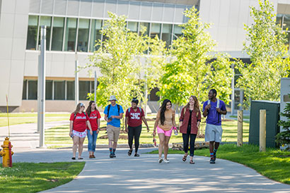 Students walking on campus in the summer